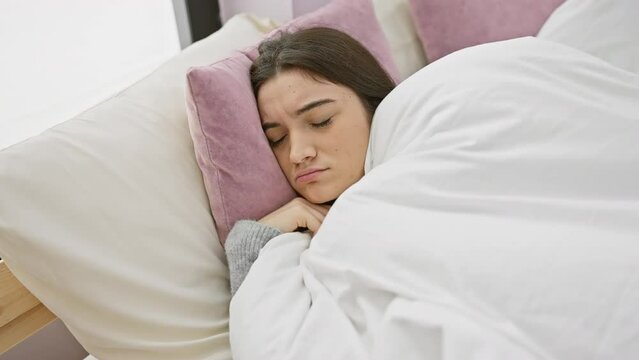 A serene young hispanic woman sleeping peacefully in a cozy bedroom setting, evoking a sense of relaxation.