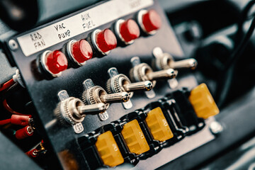 Buttons and switches of a race car control panel.