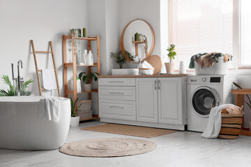 Interior of bathroom with washing machine, laundry baskets and sink - obrazy, fototapety, plakaty