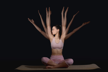 Young woman in sportswear practicing yoga in motion on black background