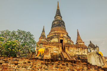 Fototapeta premium The background of important religious attractions, Wat Yai Chai Mongkhon, has an old Buddha statue and a large pagoda for tourists to study the history of Ayutthaya in Thailand.