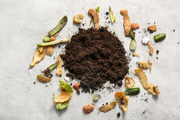 Organic waste and soil on white grunge background. Compost recycling concept