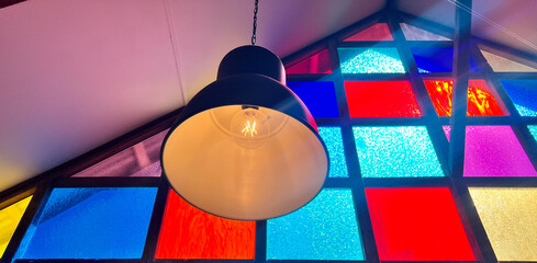 Stained glass wall and vintage lamp hanged from ceiling