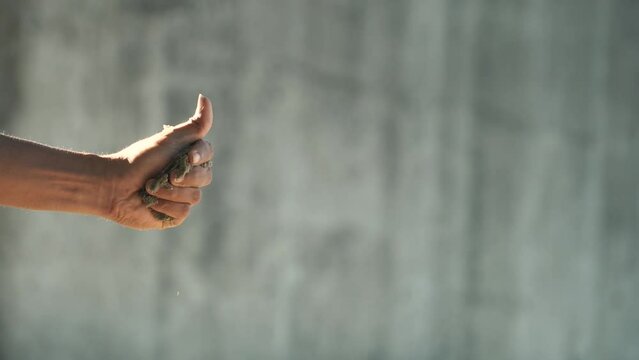 video concept of human hands holding love shaped sand and crushing it
