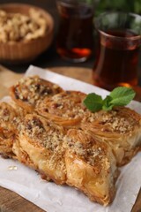 Eastern sweets. Pieces of tasty baklava and tea on table, closeup