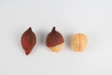 Salak snake fruit on white background. Isolated whole and halved sweet tropical snake fruit. Famous...