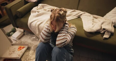 Pizza, depression or woman with food on floor frustrated by mistake, breakup or diet fail at home. Mental health, bulimia or person binge eating in living room angry, crisis or overthinking calories