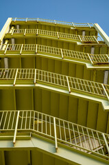 Yellow Green Fire Escape Stairway on the Exterior of a Tall Building.