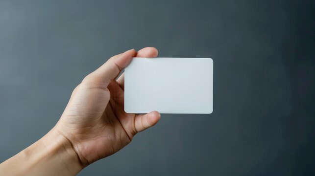 Hand hold blank white card mockup with rounded corners. Plain call-card mock up template holding arm.