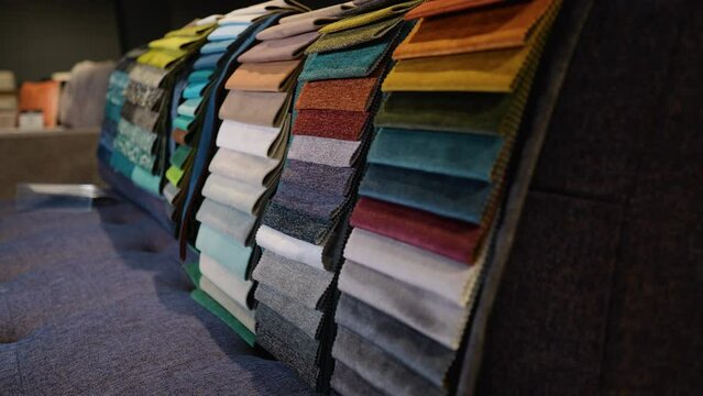 Fabric and textiles samples in a factory shop or store. Different colors and patterns on the market