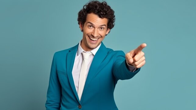 Portrait of cheerful businessman pointing at copy space for advertising against blue background