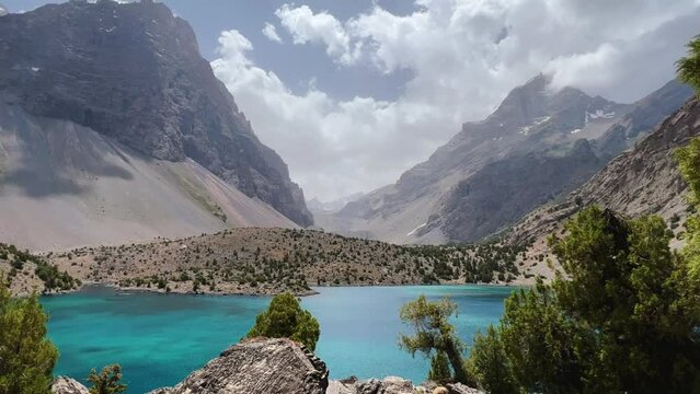 The Alaudin (Chapdara) lakes, lying at an altitude of 2800 m, are considered one of the most beautiful lakes of the Fan Mountains. Turquoise mountain lake. Pamiro-Alai. Tajikistan, Pamir 4K