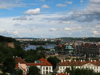 Fototapeta premium Aerial View of City Buildings in Prague, Czech Republic with blue sky and clouds