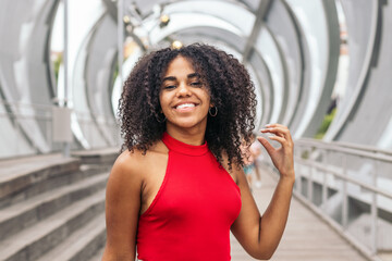 Portrait of a girl with afro hair enjoying in summer in the city
