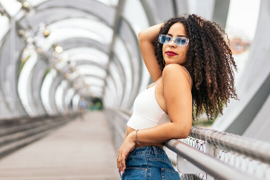 Portrait of an afro young woman enjoying the summer in the city