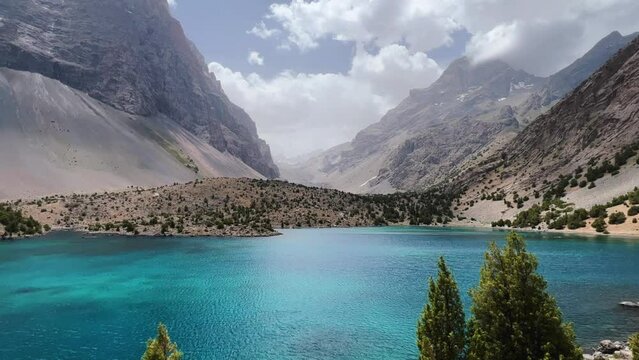 The Alaudin (Chapdara) lakes, lying at an altitude of 2800 m, are considered one of the most beautiful lakes of the Fan Mountains. Turquoise mountain lake. Pamiro-Alai. Tajikistan, Pamir 4K