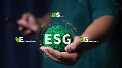 Businessman holding globe with ESG icon green earth concept for environment Society and Governance...