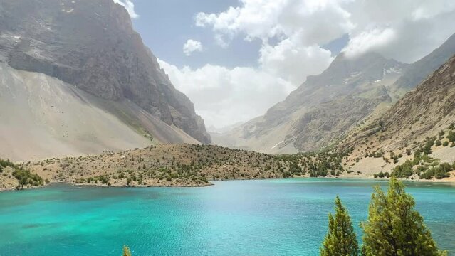 The Alaudin (Chapdara) lakes, lying at an altitude of 2800 m, are considered one of the most beautiful lakes of the Fan Mountains. Turquoise mountain lake. Pamiro-Alai. Tajikistan, Pamir 4K