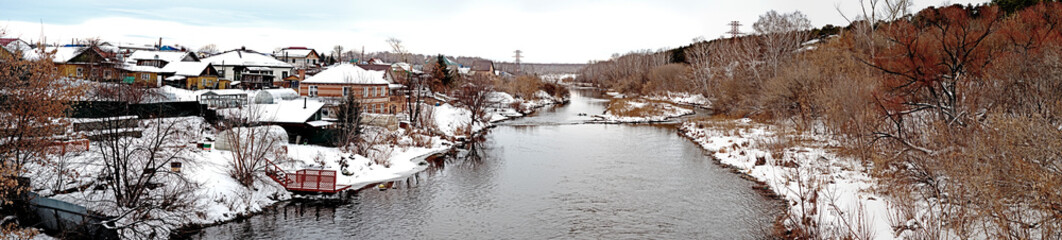 panoramic view of the coastal village on the banks of the Miass River in winter - 787746872
