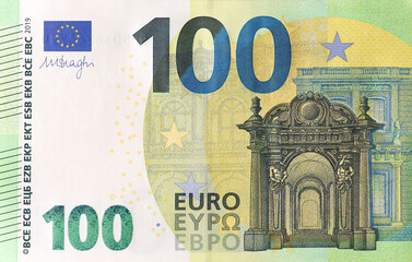 Fragment of one hundred euro money bill. Details of European union currency banknote of 100 euro close up