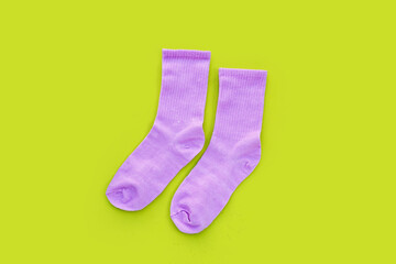 Pink socks on green background.