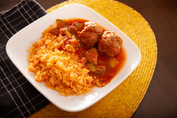 Meatballs with red rice. In Mexico they are known as Albondigas, served with vegetables in a light tomato sauce called Caldillo. Very popular recipe for homemade food in Mexico. - 787758248