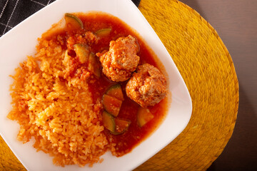Meatballs with red rice. In Mexico they are known as Albondigas, served with vegetables in a light tomato sauce called Caldillo. Very popular recipe for homemade food in Mexico. - 787758286
