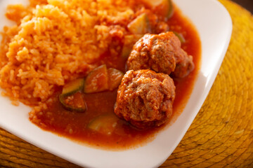 Meatballs with red rice. In Mexico they are known as Albondigas, served with vegetables in a light tomato sauce called Caldillo. Very popular recipe for homemade food in Mexico.