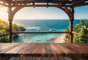 View of a tropical beach from a wooden terrace with lush greenery and clear blue sea.
