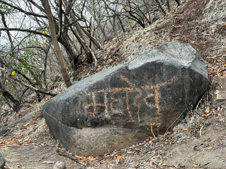 A rock with the word "Mahadev" written on it.