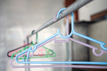 Colorful clothes hanger in a shop, closeup of photo