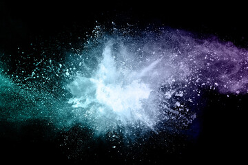 abstract colored dust explosion on a black background.abstract powder splatted background