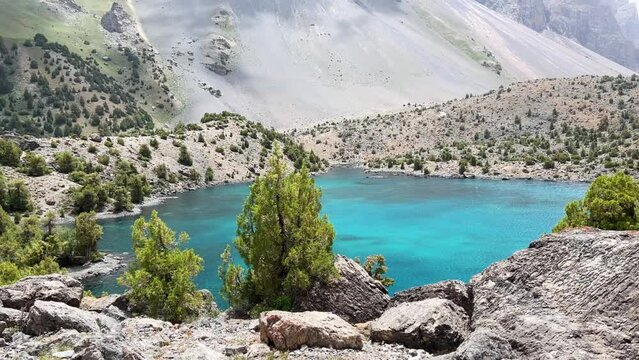 The Alaudin (Chapdara) lakes, lying at an altitude of 2800 m, are considered one of the most beautiful lakes of the Fan Mountains. Turquoise mountain lake. Pamiro-Alai. Tajikistan, Pamir 4K