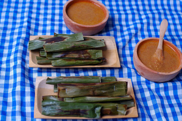 otak-otak, Grilled Fish Meat Wrapped in Coconut Leaves from Betawi, Jakarta. Served with spicy peanut sauce.