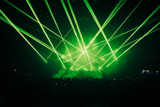Lasers at a DJ Show, with a crowd in the foreground