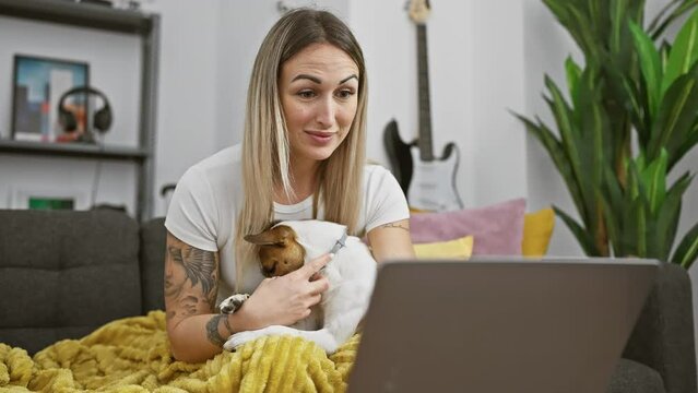A woman enjoys time at home with her dog while working on laptop, evoking themes of telework, pets, and lifestyle.