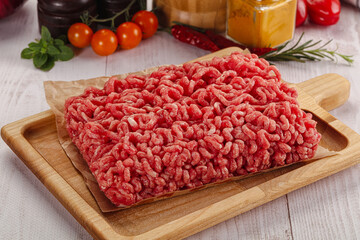 Raw minced beef meat over board