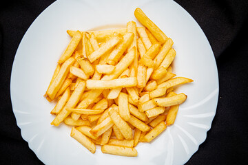 french fries on the white plate - 787803802