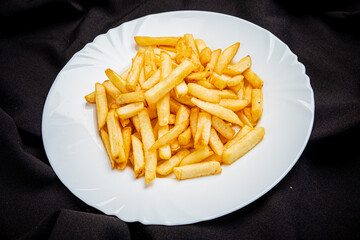 french fries on the white plate - 787803823