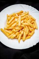 french fries on the white plate - 787803871
