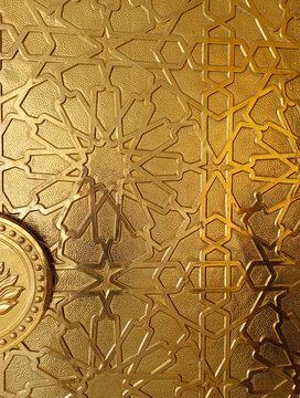 Close up Islamic motifs on the gold mosque gates
