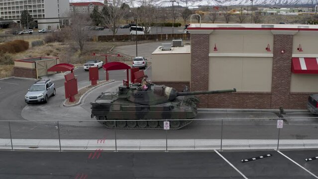 Epic drone shot flying in on tank going through drive thru