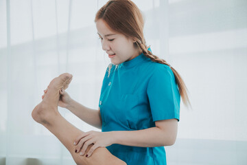 Physical therapy assistance Asian female doctor with senior man in physical therapy rehabilitation...
