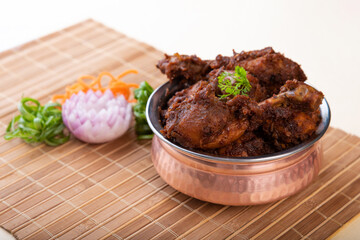 Dry chicken ghee roast in malvani, goan and konkani cuisine with nalli.