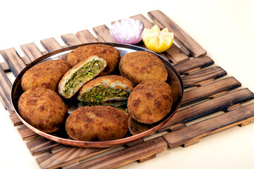 A plate of veggie patties with one cut in half.