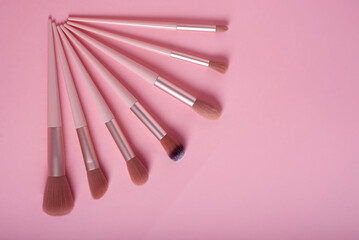 Set of makeup brushes on pink background. Makeup concept.