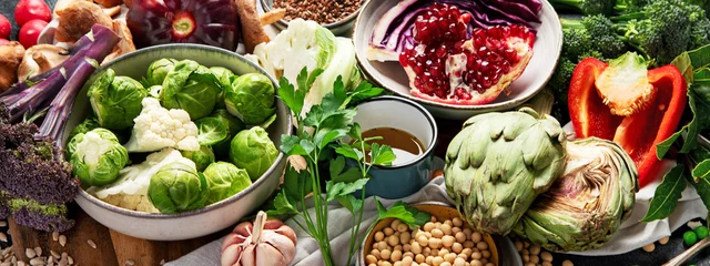  Vegan food. Pepper, broccoli, cabbage, garlic, mushrooms, pomegranate on a dark background © bit24