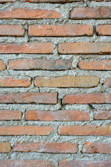 Old thin red brick wall. Textured background.