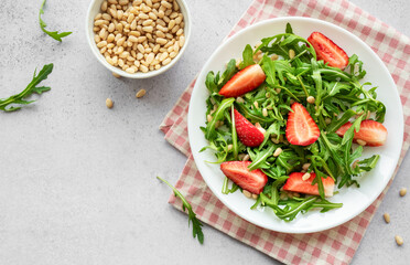 Fresh Strawberry Arugula Salad With Pine Nuts Served on a Bright Day