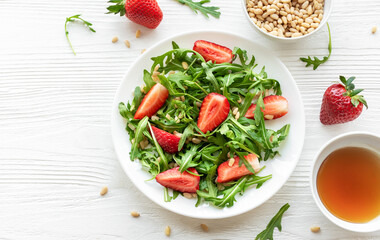 Fresh Strawberry Arugula Salad With Pine Nuts Served on a Bright Day